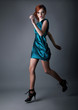 Healthy young active redhead girl running in blue dress