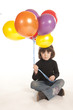Photo: cute little girl holding colorful bouquet of balloons cute little girl holding colorful bouquet of balloons
