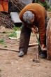 a man bending in order to fix someting at outdoor a man bending in order to fix someting at outdoor
