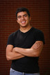 Young teenager smiling with arms crossed