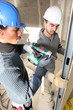 Tradesmen installing drywall