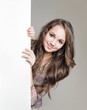 Young brunette with blank board.