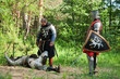 soldiers   near laying knight in armour