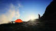 Lone Hiker by Tent on Snow Covered Rocks