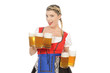 Foto: Blonde junge Frau im Dirndl mit vielen Maßkrügen Blonde junge Frau im Dirndl mit vielen Maßkrügen