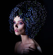 Fine girl with crown of grapes on her head