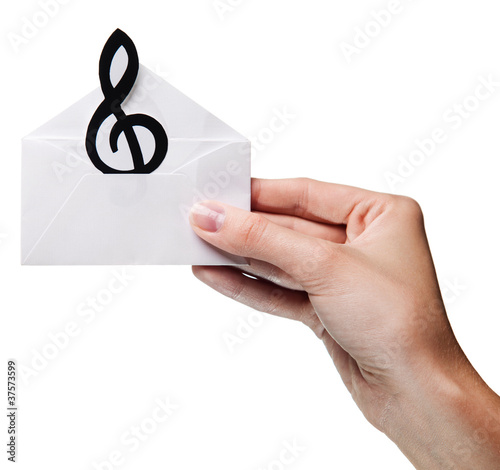 Photo: woman's hand holding an envelope with a sign of the melody isola woman's hand holding an envelope with a sign of the melody isola