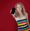 Beautiful woman holding mobilephone towards camera