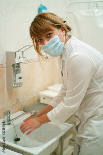 Photo: worker washing her hands worker washing her hands