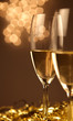 Christmas glasses of Champagne and golden background Christmas glasses of Champagne and golden background