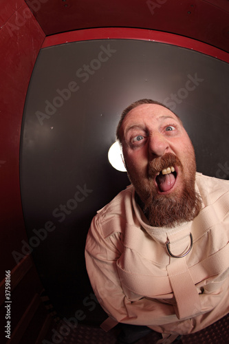 Photo: Insane man in a straitjacket Insane man in a straitjacket