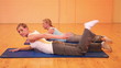 Women stretching their legs in fitness center