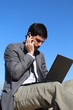 A businessman is talking on his smartphone outdoor
