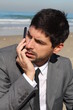 Young and handsome businessman talks on his smartphone