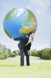 Businessman holding large ball on back