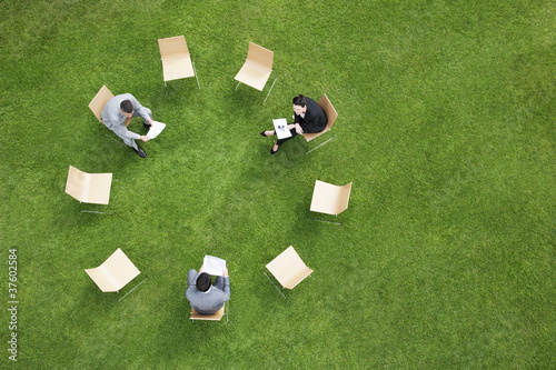 Photo: Business people having meeting outdoors Business people having meeting outdoors