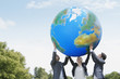 Business people lifting large ball together