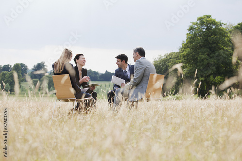 Photo: Business people having meeting outdoors Business people having meeting outdoors