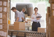 Foto: Woman holding scanner in shipping warehouse Woman holding scanner in shipping warehouse