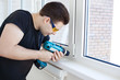 Man worker mounting window