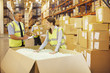 Workers checking box in warehouse