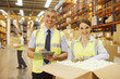 Workers in warehouse standing near box