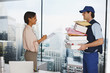 Businesswoman signing for package in office