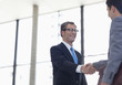 Businessmen shaking hands together