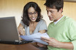 Couple paying bills on laptop together