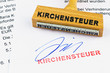 Holzstempel auf Dokument: Kirchensteuer