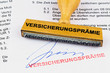 Holzstempel : Versicherungsprämie