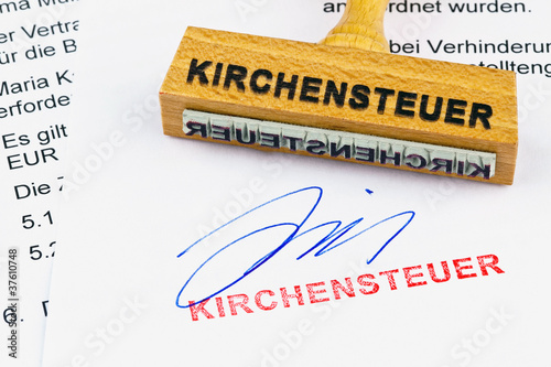 Photo: Holzstempel auf Dokument: Kirchensteuer Holzstempel auf Dokument: Kirchensteuer