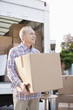 Man unloading box from moving van