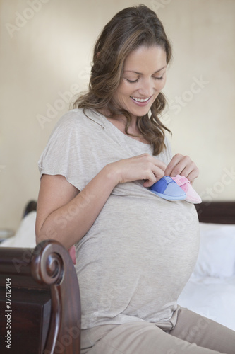 Photo: Expectant mother holding baby booties Expectant mother holding baby booties