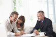 Couple signing contract with financial advisor