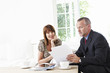 Financial advisor explaining paperwork to customer