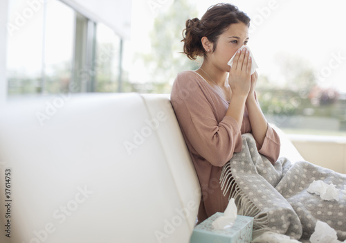 Photo: Sick woman blowing her nose Sick woman blowing her nose