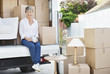 Woman drinking coffee on back of moving van
