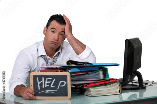 Photo: Overworked white collar working crying out for help Overworked white collar working crying out for help