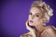 The image of a beautiful luxurious woman on purple background. S The image of a beautiful luxurious woman on purple background. S