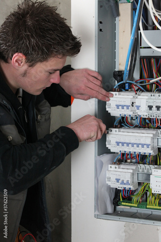 Photo: Electrician checking a distribution board Electrician checking a distribution board