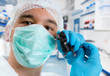 Scientist holds black mouse