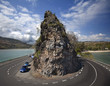 Kind on abrupt turn of road and a rock at coast