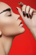 Profile woman with strong eyebrows makeup, black manicure