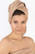 Beautiful young woman with a towel on her head.
