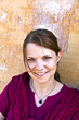 portrait of beautiful caucasian woman with old wall as backgroun
