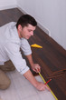 Man fitting a wooden floor