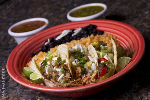 Photo: Three tacos on a red plate Three tacos on a red plate