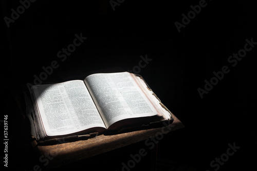 Photo: Open bible lying on a table Open bible lying on a table