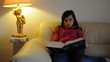 Mädchen liest ein Buch auf dem Sofa